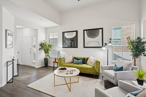 A living room with a green couch and a coffee table.